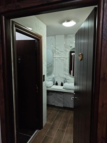 a bathroom with a tub and a sink and a mirror at Under the rocks luxury in Kalabaka