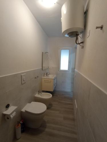 ein weißes Badezimmer mit Toilette und Waschbecken in der Unterkunft CasAmedeo in Calasetta