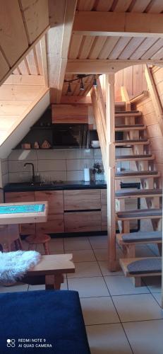 a kitchen with a spiral staircase in a house at Pokoje ,,Goramiba''Jurgów in Jurgów