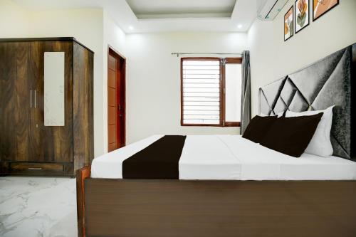 a bedroom with a large bed and a window at Hotel O Classic in in Kharar