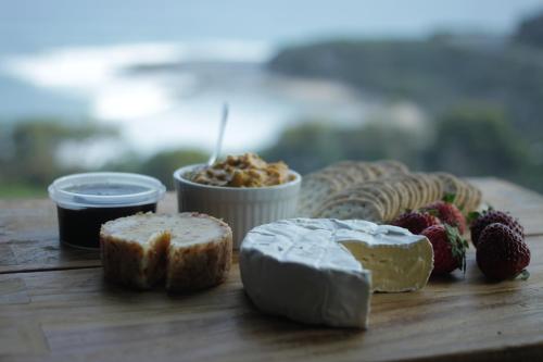 a table topped with different types of bread and fruit at Points South By The Sea in Apollo Bay