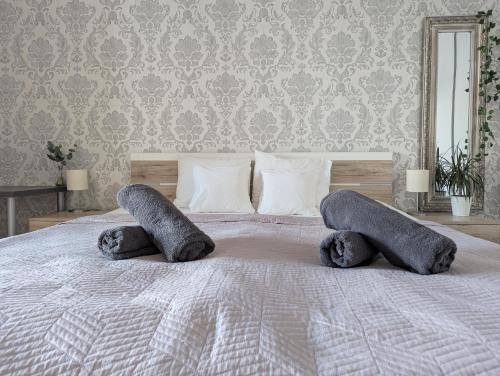 a bedroom with a bed with two pillows on it at Sunset stay - Stunning views & Romantic Experience Option in Bratislava