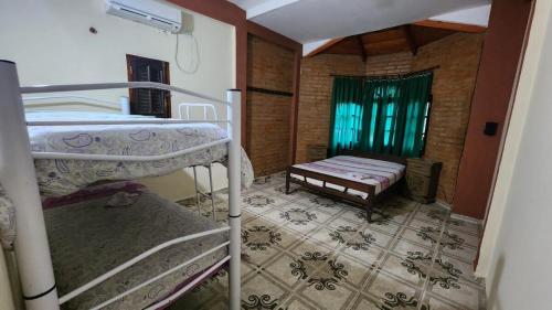 a room with two bunk beds and a window at Casa Rivadavia en El Paso in Paso de la Patria