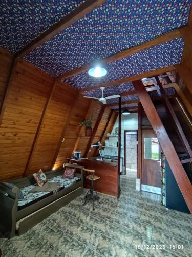 a room with a bed and a desk in it at Chalés Caraguatatuba in Caraguatatuba
