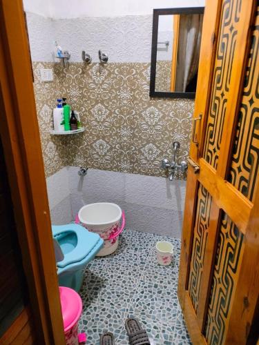 a bathroom with two toilets and a sink at Golden Mud in Srinagar