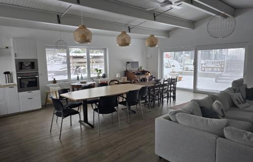 a living room with a couch and a table and chairs at vakantiehuis 't Loreem in Geraardsbergen