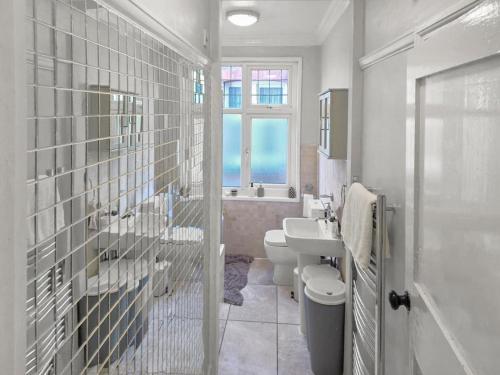a bathroom with a toilet and a sink and a shower at 3-Bed Duplex Flat, Free WIFI & Great Transport Links in Norwood