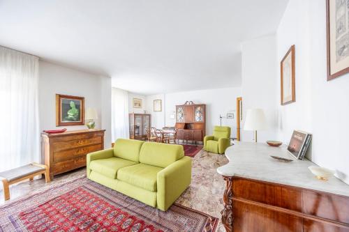 a living room with a yellow couch and a table at Italian Experience-Mestrina Apartment in Mestre