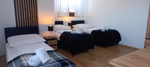 a bedroom with two beds with black and white at D.W. Harnaś in Białka Tatrzańska