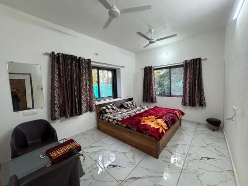 a bedroom with a bed and a chair in it at Ranchhod Villa in Marwad