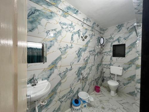 a bathroom with a sink and a toilet at Ranchhod Villa in Marwad