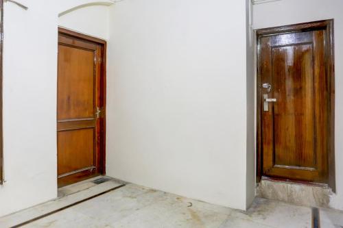 an empty room with two doors on a wall at Hotel O Green Park Residency 2 in New Delhi