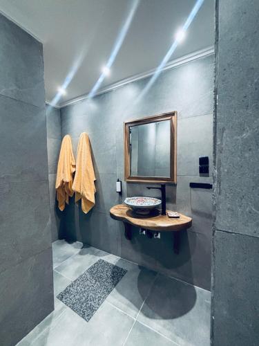a bathroom with a sink and a mirror at Inass appartement in Essaouira