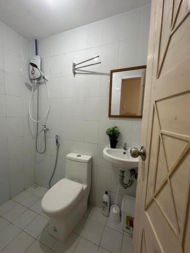 a bathroom with a toilet and a sink at Ormoc Gdex Transient in Ormoc