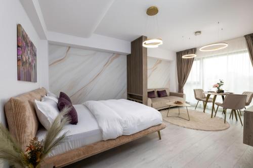 a bedroom with a bed and a dining room at Lila Residence - by Solinis Homes in Bucharest