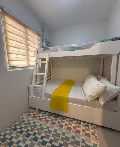 a bunk bed with a ladder in a room at Ormoc Gdex Transient in Ormoc