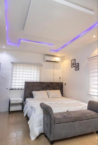 a bedroom with a bed and a couch at 4 Kays Apartment in Agege
