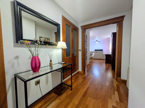 a living room with a vase on a glass table at Apartamento Córdoba Center in Córdoba