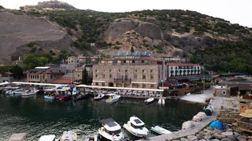 a group of boats are docked in a harbor at Assos Troy Port Hotel in Behramkale