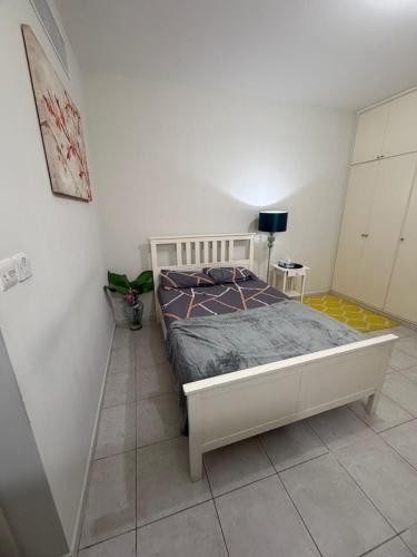 a bedroom with a bed in a white room at Studio Room with Private Bathroom & kitchen in Abu Dhabi