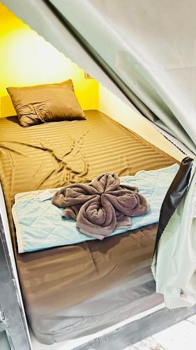 a bed in a tent with a blanket on it at Rc Guest House in Phi Phi Islands