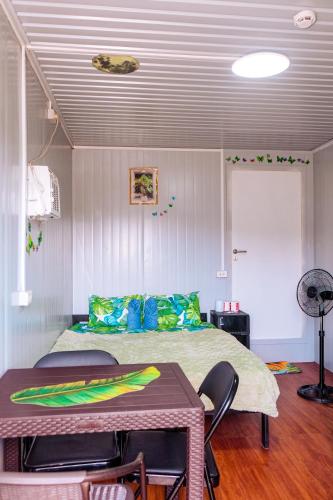 a bedroom with a bed and a table and chairs at Banana Bar San Juan Family Digital Nomad Stay Starlink Fast WiFi Solar Backup in San Juan