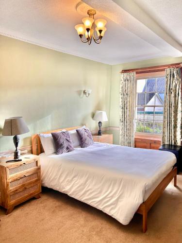 a bedroom with a large bed and a window at The Beacons Guest House in Brecon