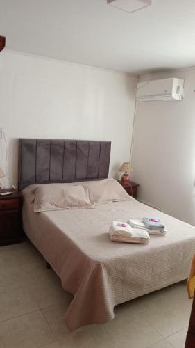 a bedroom with a bed with two towels on it at Abuela Chiquita in Ramallo