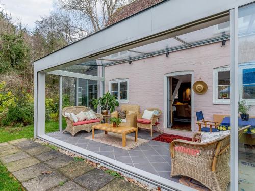 an extension of a house with sliding glass doors at Highlands Farmhouse in Dallington