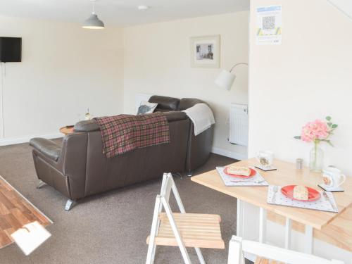 a living room with a couch and a table at Swan's Nest - Uk43545 in Belford