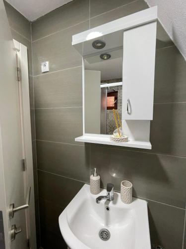 a bathroom with a sink and a mirror at The Tara Concept in Šljivovica