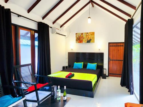 a bedroom with a bed and a chair at Euro Elephant Yala in Tissamaharama