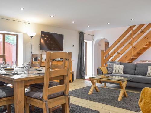 a living room with a table and a couch at Mill House Barn in Warmingham