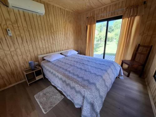 a bedroom with a bed and a large window at TINY HOUSE Los Angeles in Los Ángeles