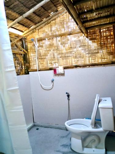 a bathroom with a toilet and a shower at Kohmook Money RUEAN PHAI in Trang