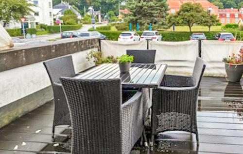 a table and chairs on a balcony with a street at 1 Bedroom Nice Apartment In Helsingør in Helsingør