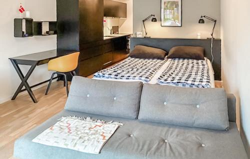 a couch with a bed in a room at 1 Bedroom Nice Apartment In Helsingør in Helsingør