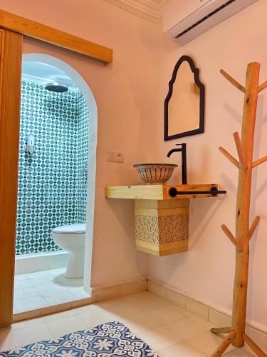 a bathroom with a toilet and a sink at Riad Dar Home in Tétouan