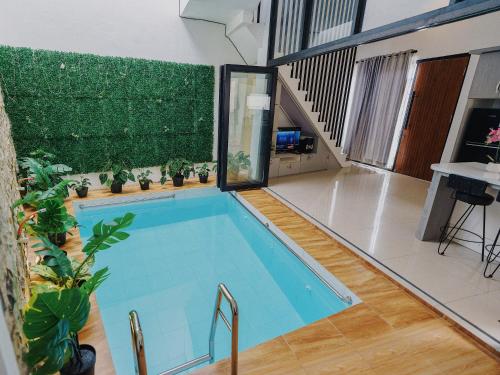 a swimming pool in a house with a large window at TITANIUM 9 Villa in Tlekung