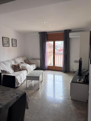 a living room with a couch and a table at Casa Rosa in Alcañiz