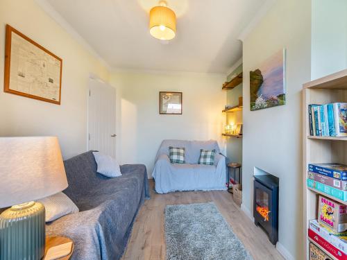 a living room with a couch and a chair at Arosfa in St. Davids