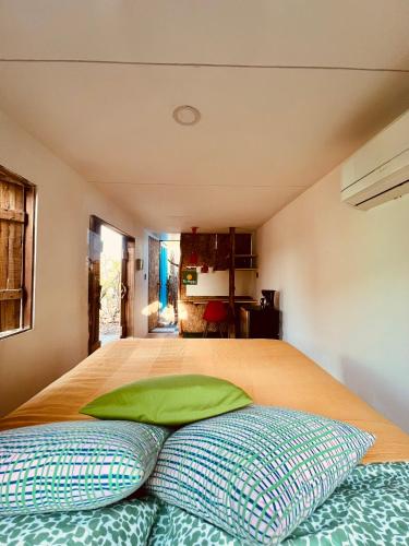 a bedroom with a bed with two pillows on it at Mojarra Beach-Wind Room- Santa Veronica in Salina de Rey
