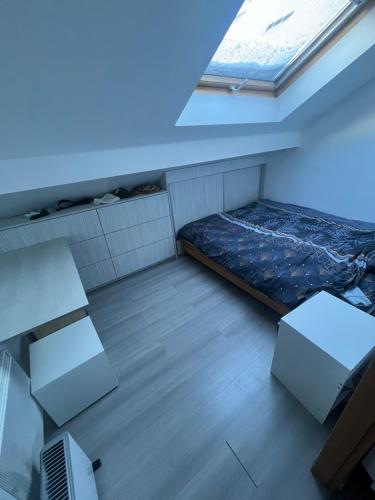 mały pokój z łóżkiem i oknem w obiekcie Studio chambre w mieście Cruseilles