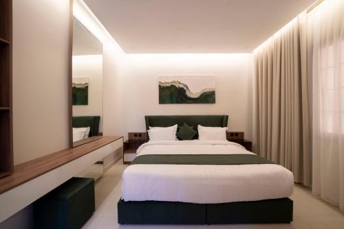 a bedroom with a large bed and a mirror at اسوار بلس - Aswar Plus in Tabuk