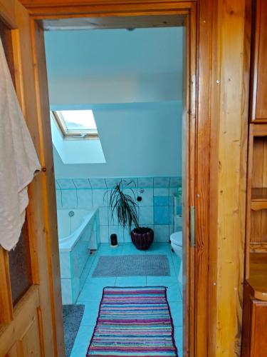 a bathroom with a tub and a toilet and a sink at Agroturystyka u Anieli - Wśród Gór i Ziół in Krośnica