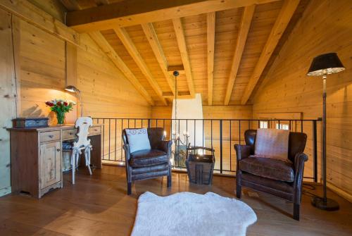 a room with two chairs and a table and a lamp at Chalet Dunmore in Verbier