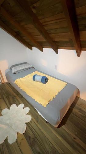 a bed with a tool on top of it at Casinha do Rosa in Imbituba