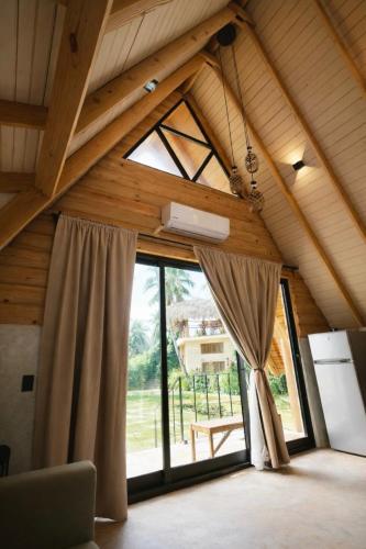 a room with a large window in a attic at Casa Cayena - Hibiscus House in El Valle