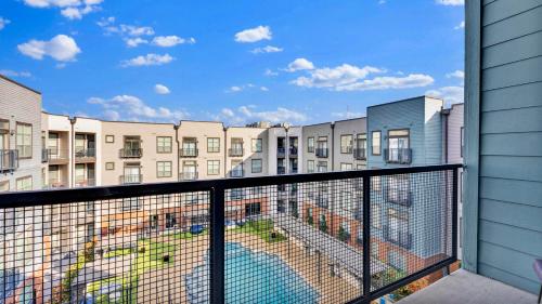 an apartment balcony with a view of buildings at Apartmint at Deep Ellum - Dallas in Dallas