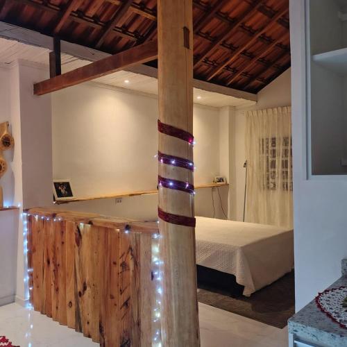a bedroom with a bed and a tub in a room at Chácara Sitara - Chalé Safira in Caldas